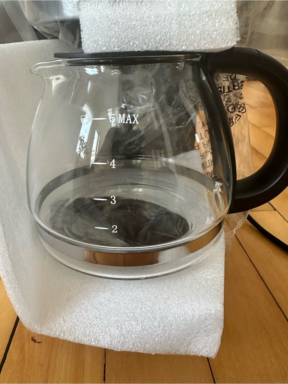 Clear Glass Coffee Carafe with Black Handle and Chrome Accent